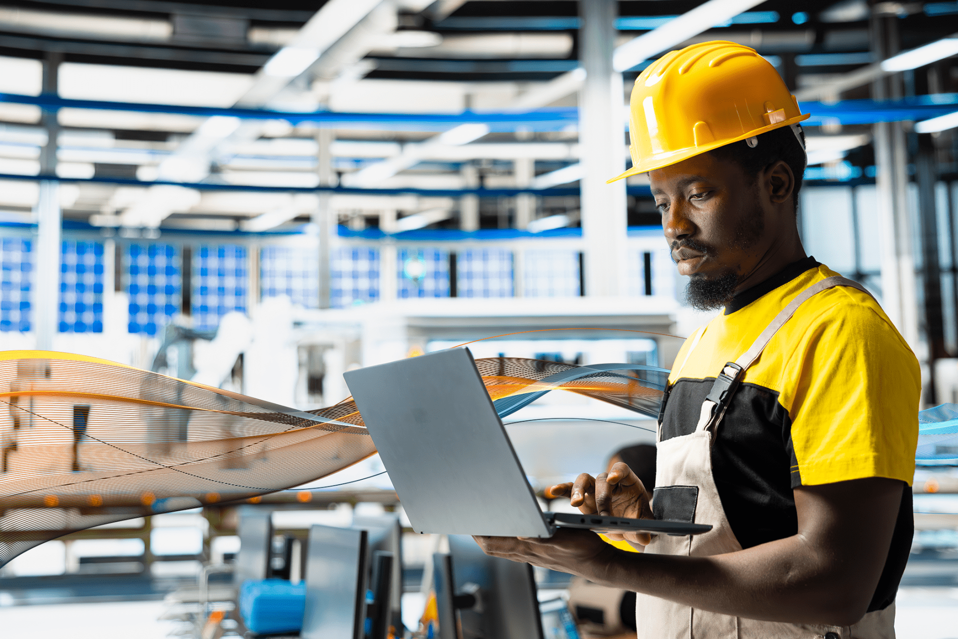 Employee in a factory working on a laptop