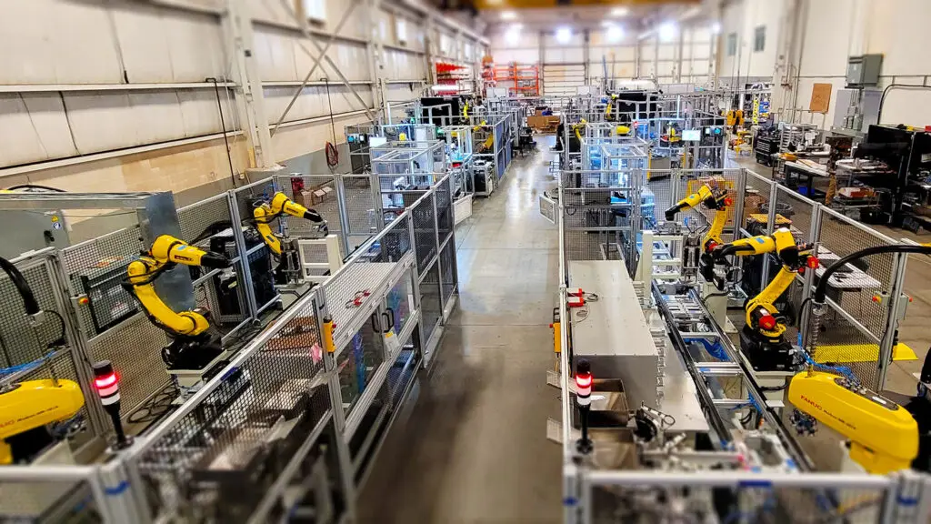Industrial automation factory with robotic arms and conveyors