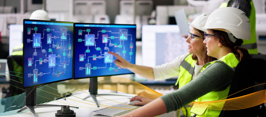 Two automation engineers looking at digital factory schematic